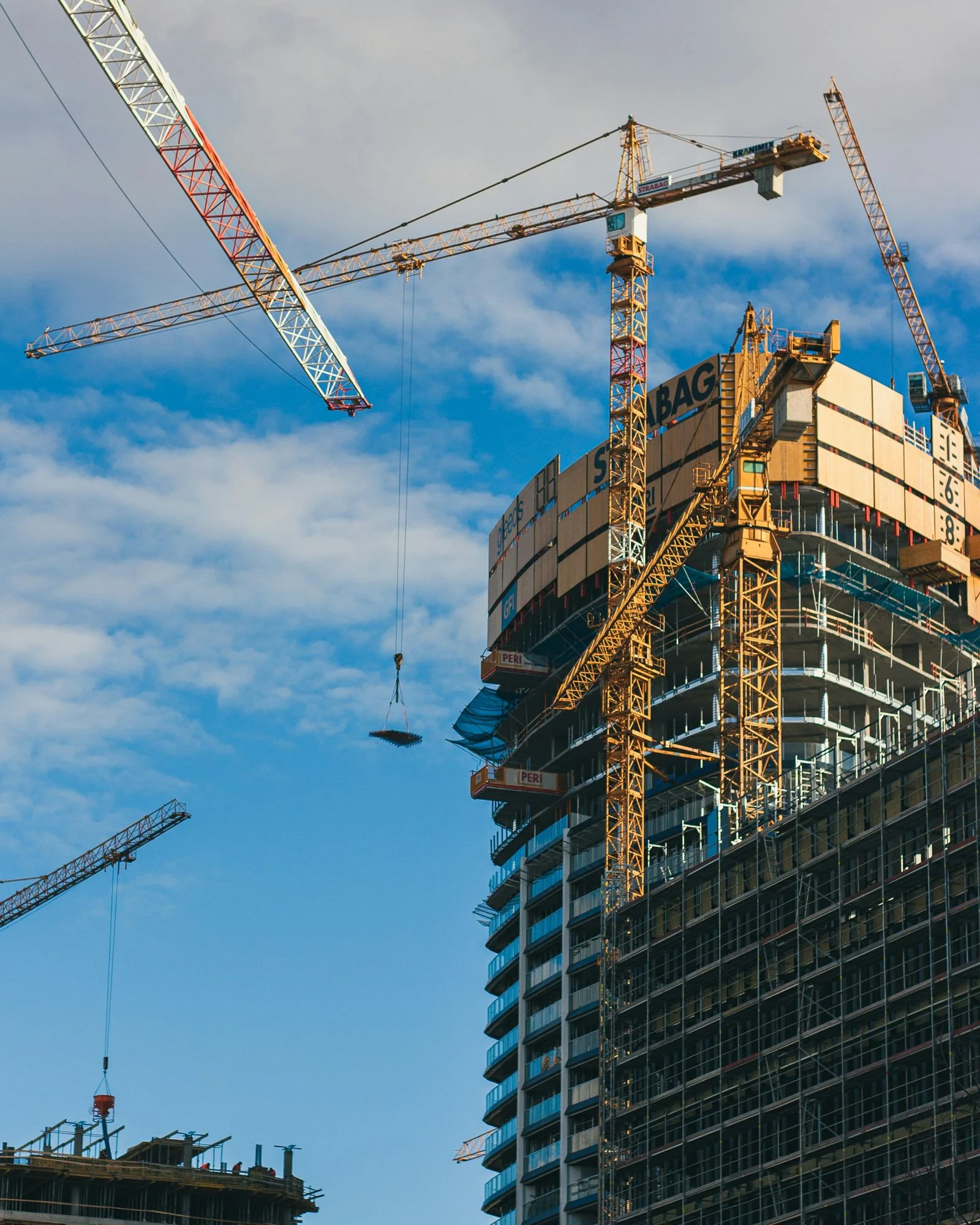 Cranes over a tower under construction