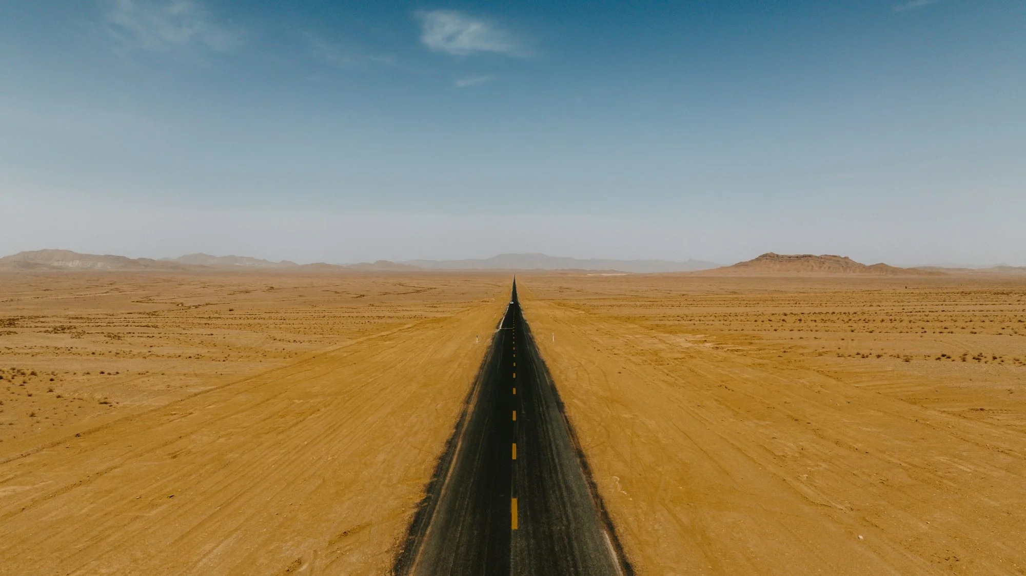 A straight road across open desert land